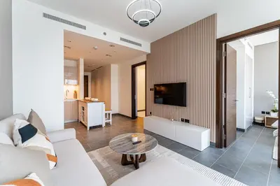 a living room with a couch and a table at HAVN - 2 Bedroom at The Crest, Dubai Skyline Views in Dubai