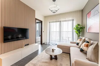 a living room with a couch and a tv at HAVN - 2 Bedroom at The Crest, Dubai Skyline Views in Dubai