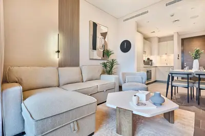 a living room with a couch and a table at STAY BY LATINEM Luxury 1BR Holiday Home CB 0905 Near Burj Khalifa in Dubai