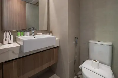 a bathroom with a sink and a toilet and a mirror at Stylish Studio Apartment in Azizi Riviera One in Dubai