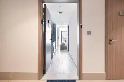 a hallway with a mirror in a house at Stylish Studio Apartment in Azizi Riviera One in Dubai