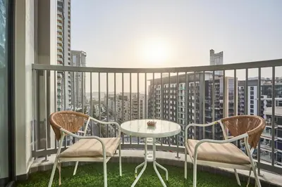 a balcony with a table and chairs and a view at STAY BY LATINEM Luxury 2BR Holiday Home CC 1014 Near Burj Khalifa in Dubai