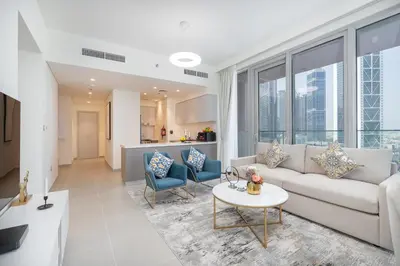 a living room with a couch and a table at Vogue Downtown Forte near Dubai Mall and Burj Khalifa, Two-Bedroom Apartment with Balcony and City View, full access to all amenities in Dubai