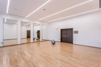 a large white room with a wooden floor and mirrors at Vogue Downtown Forte near Dubai Mall and Burj Khalifa, Two-Bedroom Apartment with Balcony and City View, full access to all amenities in Dubai