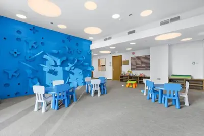 a room with blue tables and chairs in a classroom at Vogue Downtown Forte near Dubai Mall and Burj Khalifa, Two-Bedroom Apartment with Balcony and City View, full access to all amenities in Dubai
