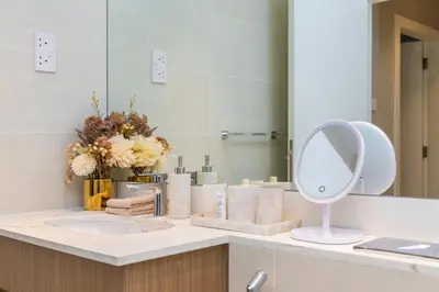 a bathroom counter with a sink and a mirror at NEU Sea and Burj View Port de La Mer in Dubai