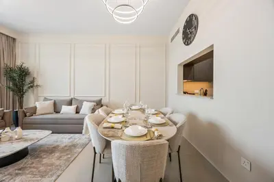 a living room with a table and a couch at 2BR Apt Direct Dubai Mall Access Burj View in Dubai