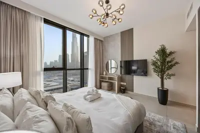 a bedroom with a large white bed and a large window at 2BR Apt Direct Dubai Mall Access Burj View in Dubai