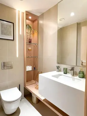 a bathroom with a white sink and a toilet at Gym Spa Padel & E-scooter Designer Brand New 2BR in Dubai