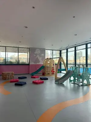 a childrens play room with slides and swings at Gym Spa Padel & E-scooter Designer Brand New 2BR in Dubai