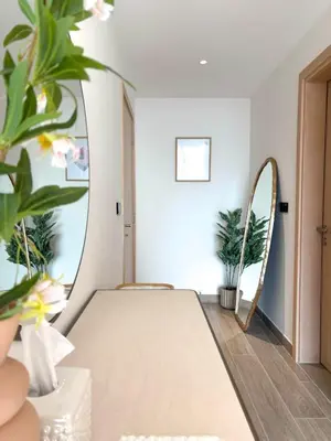 a bedroom with a bed and a mirror at Gym Spa Padel & E-scooter Designer Brand New 2BR in Dubai