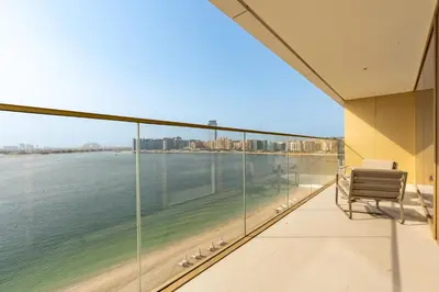 a balcony with a view of the ocean at Chic 2 bedroom w Sunset and Palm Jumeirah Views in Dubai