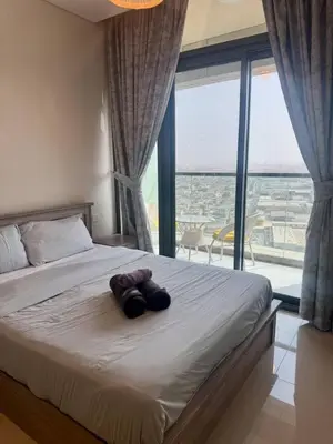 a bedroom with a large bed with a large window at Samani vacation homes 2217 in Dubai