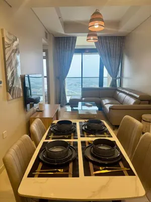 a living room with a table with a stove top at Samani vacation homes 2217 in Dubai