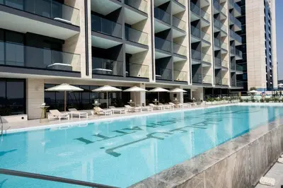 a large swimming pool in front of a building at Modern Studio with Private Jacuzzi in Dubai