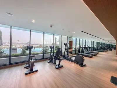 a gym with a bunch of tread machines in a building at Modern Studio with Private Jacuzzi in Dubai