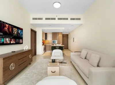 a living room with a couch and a tv at Downtown Charm Burj View 1BR in Dubai