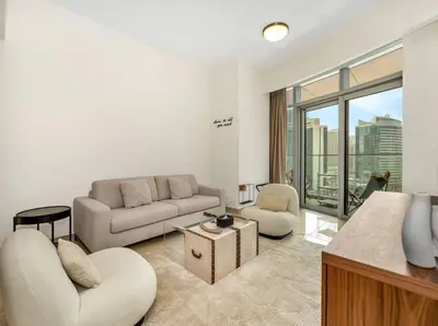 a living room with a couch and a table at Downtown Charm Burj View 1BR in Dubai