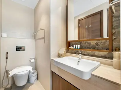 a bathroom with a sink and a toilet at Downtown Charm Burj View 1BR in Dubai