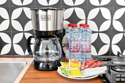 a blender on a counter with bottles of water at Dubai Hills 2BR Collective Tower in Dubai