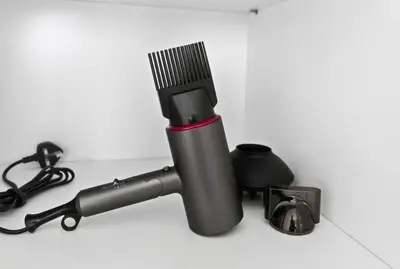 a black hair brush sitting on a white counter at Dubai Hills 2BR Collective Tower in Dubai