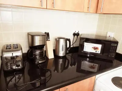 a kitchen counter with a coffee maker and a microwave at Marine View Tower aparthotel in Dubai