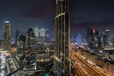 a view of a city at night with traffic at Abi Holiday Homes - Studio & 1BR Dubai Mall Fashion Avenue Residences in Dubai