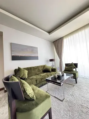 a living room with a couch and a table at Abi Holiday Homes - Studio & 1BR Dubai Mall Fashion Avenue Residences in Dubai