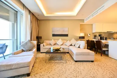 a living room with a couch and a table at Abi Holiday Homes - Studio & 1BR Dubai Mall Fashion Avenue Residences in Dubai