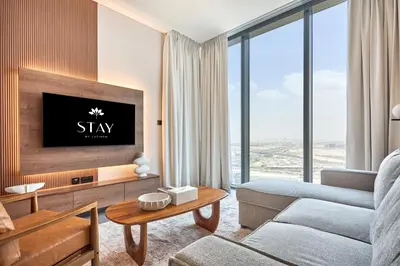 a living room with a couch and a tv at STAY BY LATINEM Luxury 1BR Holiday Home CB 2701 Near Burj Khalifa in Dubai