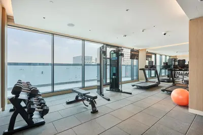 a gym with treadmills and exercise equipment in a building at STAY BY LATINEM Luxury 1BR Holiday Home CB 2701 Near Burj Khalifa in Dubai