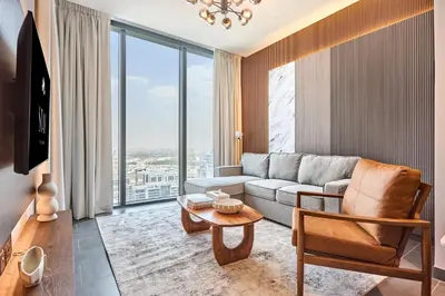 a living room with a couch and a table at STAY BY LATINEM Luxury 1BR Holiday Home CB 2701 Near Burj Khalifa in Dubai