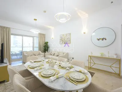 a white living room with a table and chairs at Spacious 3BR in Zen Tower Dubai Marina in Dubai