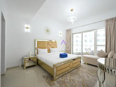 a white bedroom with a bed and a couch at Spacious 3BR in Zen Tower Dubai Marina in Dubai