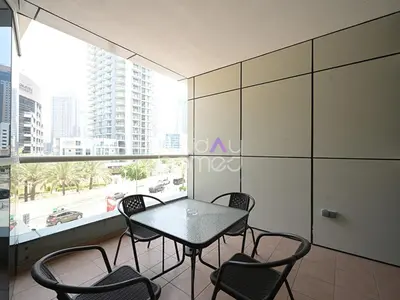 a table and chairs in a room with a window at Spacious 3BR in Zen Tower Dubai Marina in Dubai
