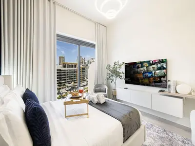 a bedroom with a large bed and a large window at Livin' Holidays - Studio - Azizi Near Downtown in Dubai