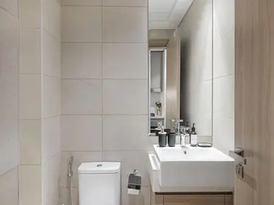 a bathroom with a white sink and a toilet at Livin' Holidays - Studio - Azizi Near Downtown in Dubai