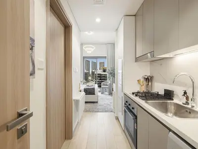 a kitchen with a sink and a stove at Livin' Holidays - Studio - Azizi Near Downtown in Dubai