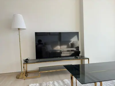 a living room with a flat screen tv on a table at Stylish One Bedroom Apartment at Binghatti Crest, JVC Dubai By al sarya Holiday Homes in Dubai