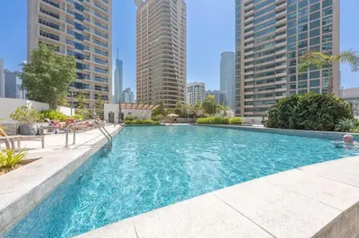 a swimming pool in a city with tall buildings at StayShort - Dubai Marina sleeps 4 with Water Views! in Dubai