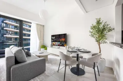 a living room with a couch and a table at StayShort - Dubai Marina sleeps 4 with Water Views! in Dubai