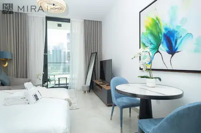 a hotel room with a bed and a table at Mira Holiday Homes - Paragon by IGO Studio Where Style Meets Comfort in Dubai