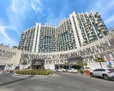 a large building with cars parked in front of it at Elegant Apartment with Burj Khalifa View in Dubai