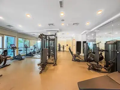 a gym with several treadmills and machines in a room at Vogue Downtown Boulevard Central near Burj Khalifa and Dubai Mall, Two Bedroom Apartment with Balcony and Burj Khalifa View, Access to all Amenities in Dubai