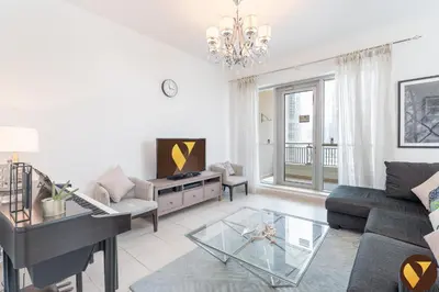 a living room with a piano and a couch at Vogue Downtown Boulevard Central near Burj Khalifa and Dubai Mall, Two Bedroom Apartment with Balcony and Burj Khalifa View, Access to all Amenities in Dubai