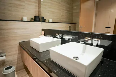 a bathroom with a white sink and a mirror at 2-Bed Apartment with Infinity Pool in Dubai