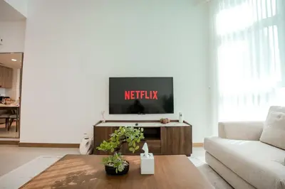 a living room with a television on a table at 2-Bed Apartment with Infinity Pool in Dubai