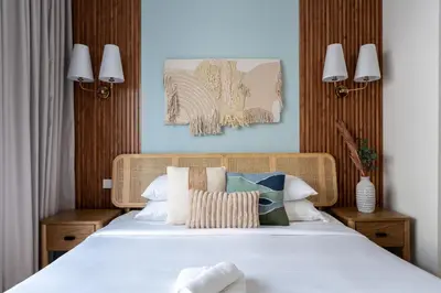 a bedroom with a bed with white sheets and pillows at GuestReady - Coastal Style l 2Bed l Lagoon Escape in Dubai