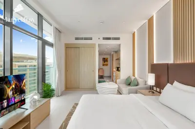 a bedroom with a large bed and a living room at MarvelStay-Infinity Pool-Beachfront-The Palm in Dubai