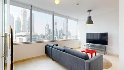 a living room with a couch and a large window at Sky Gardens - High Rise Studio with Cityscape View in Dubai